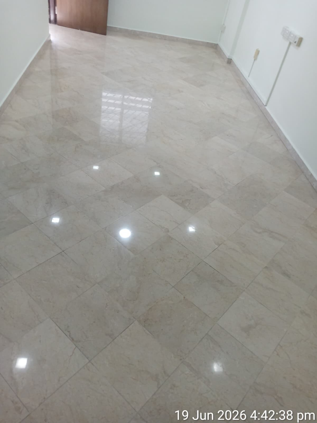 Freshly polished cream tile floor in another room of the same flat