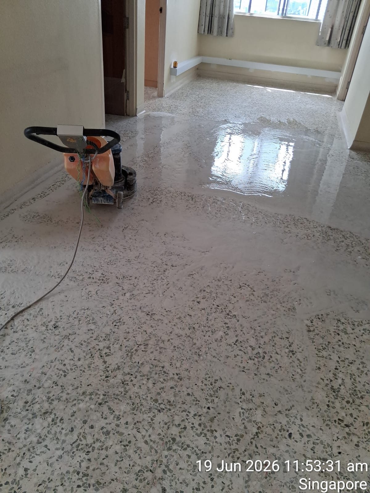 Diamond grinding a terrazzo corridor floor mid-job