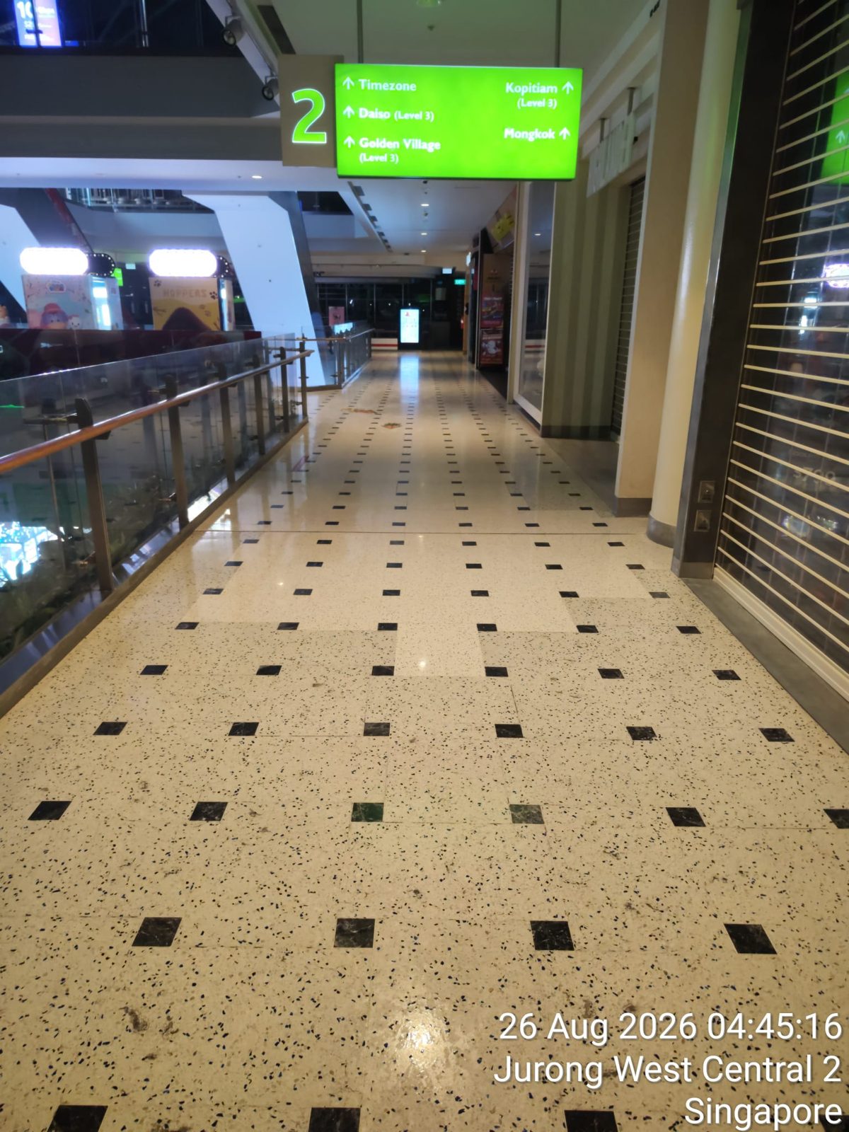 Polished terrazzo corridor beneath a mall directory sign