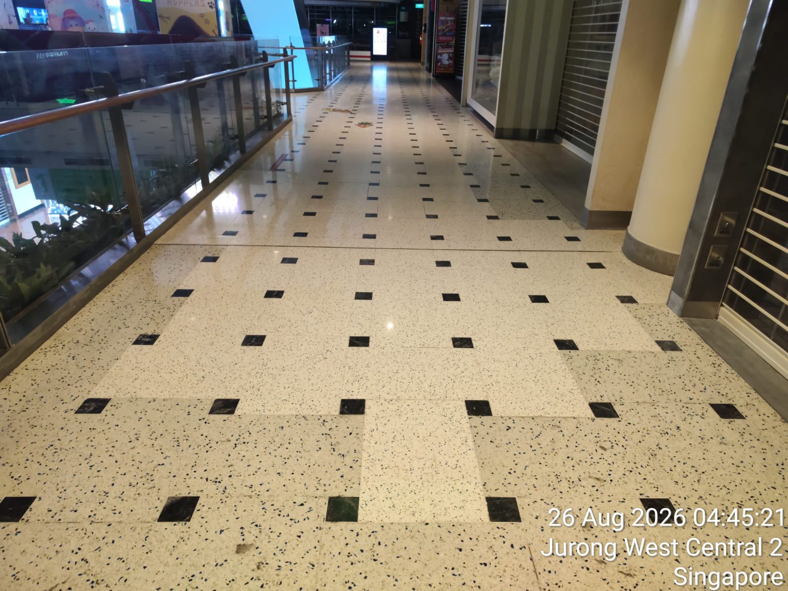 Polished terrazzo upper-level walkway overlooking the mall atrium