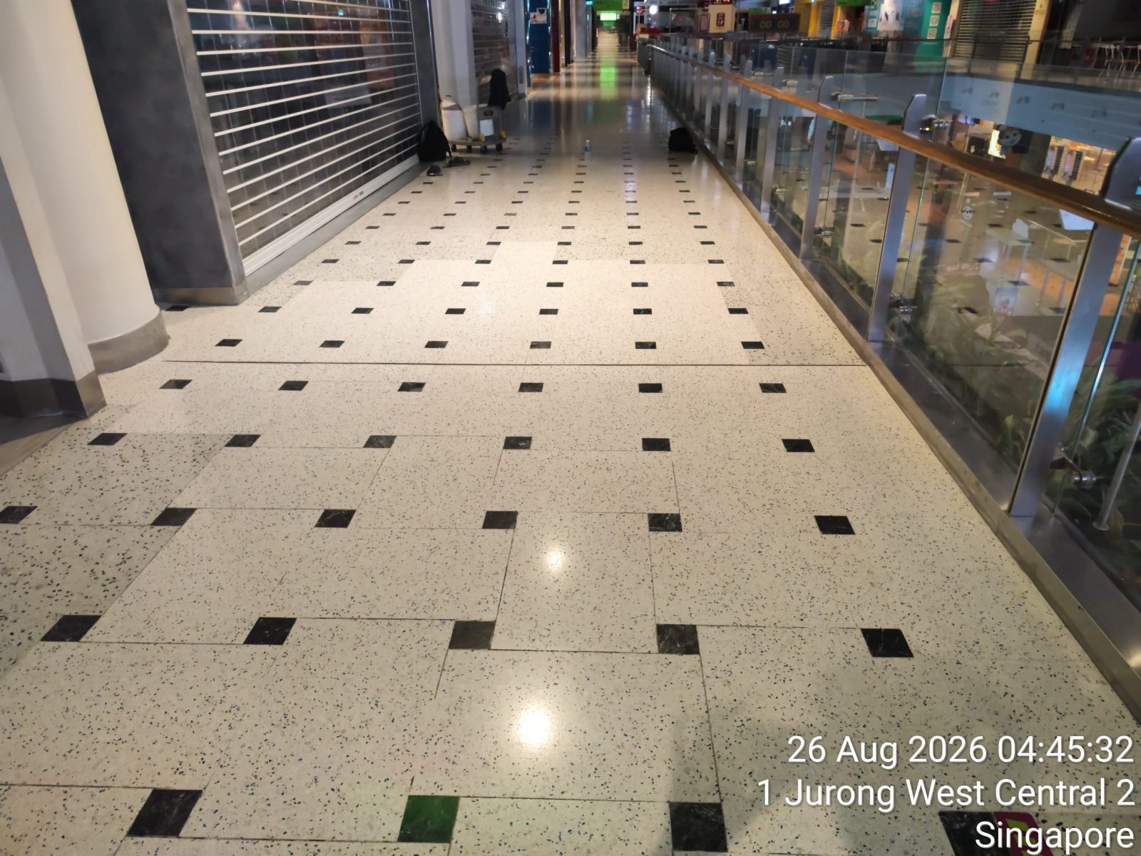Polished terrazzo walkway past shuttered mall storefronts
