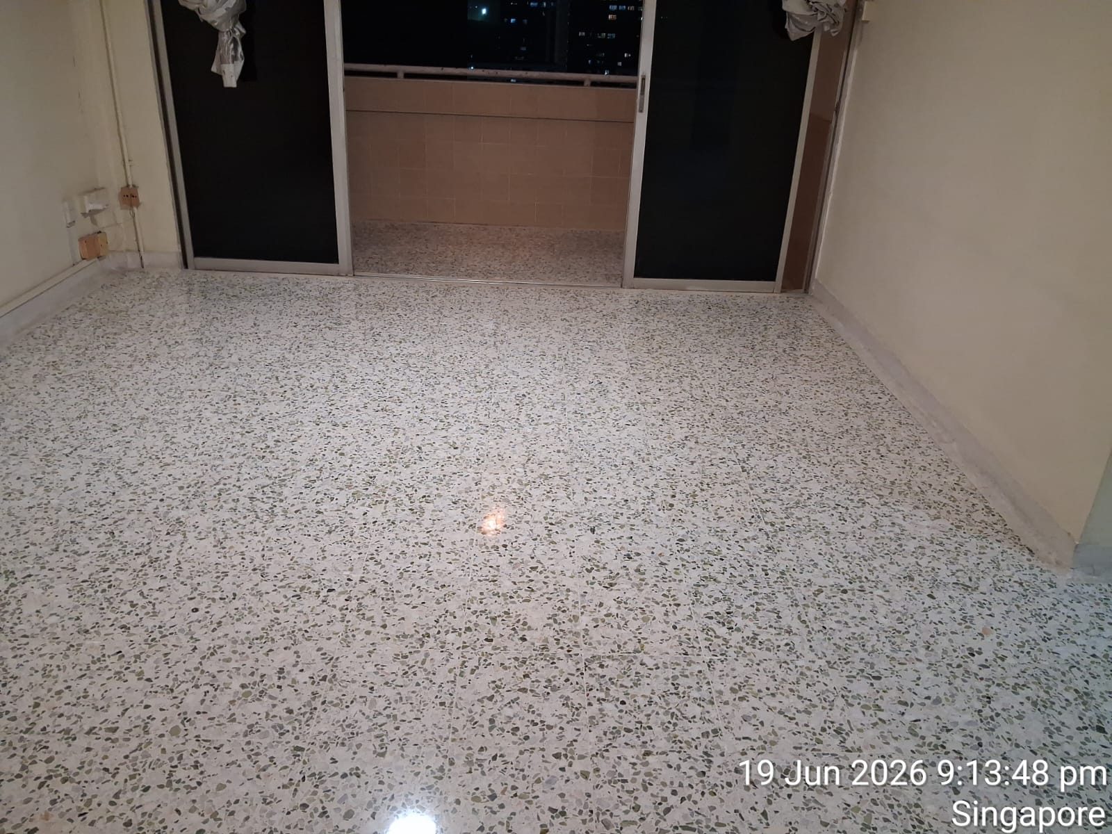 Freshly polished terrazzo second bedroom floor with dresser and window