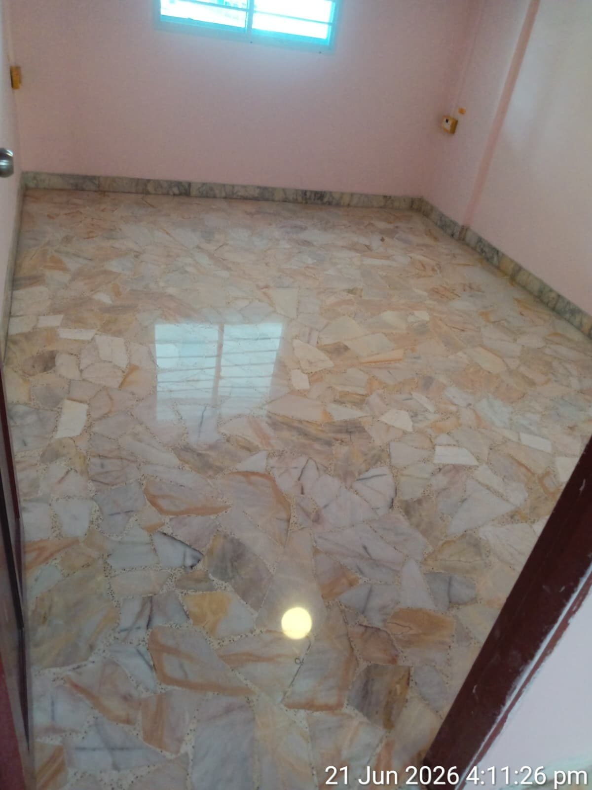 Freshly polished orange-and-grey chip terrazzo bedroom floor in a Singapore home