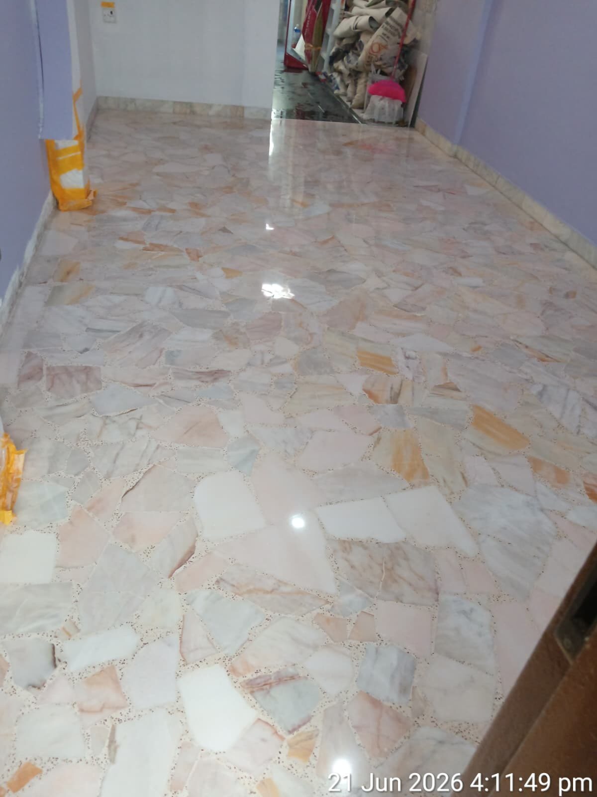 Freshly polished orange-and-grey chip terrazzo bedroom floor in a Singapore home — second photo